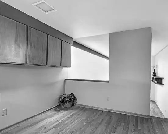 Modern minimalist interior with wooden cabinets and hardwood flooring.