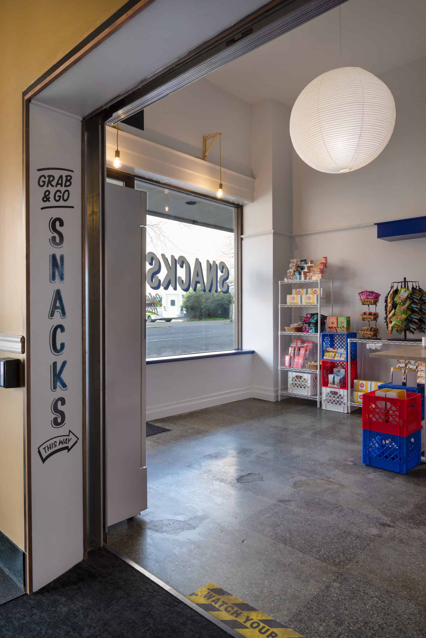 Modern snack area inside Office of Ordinary Architecture with snacks and seating.