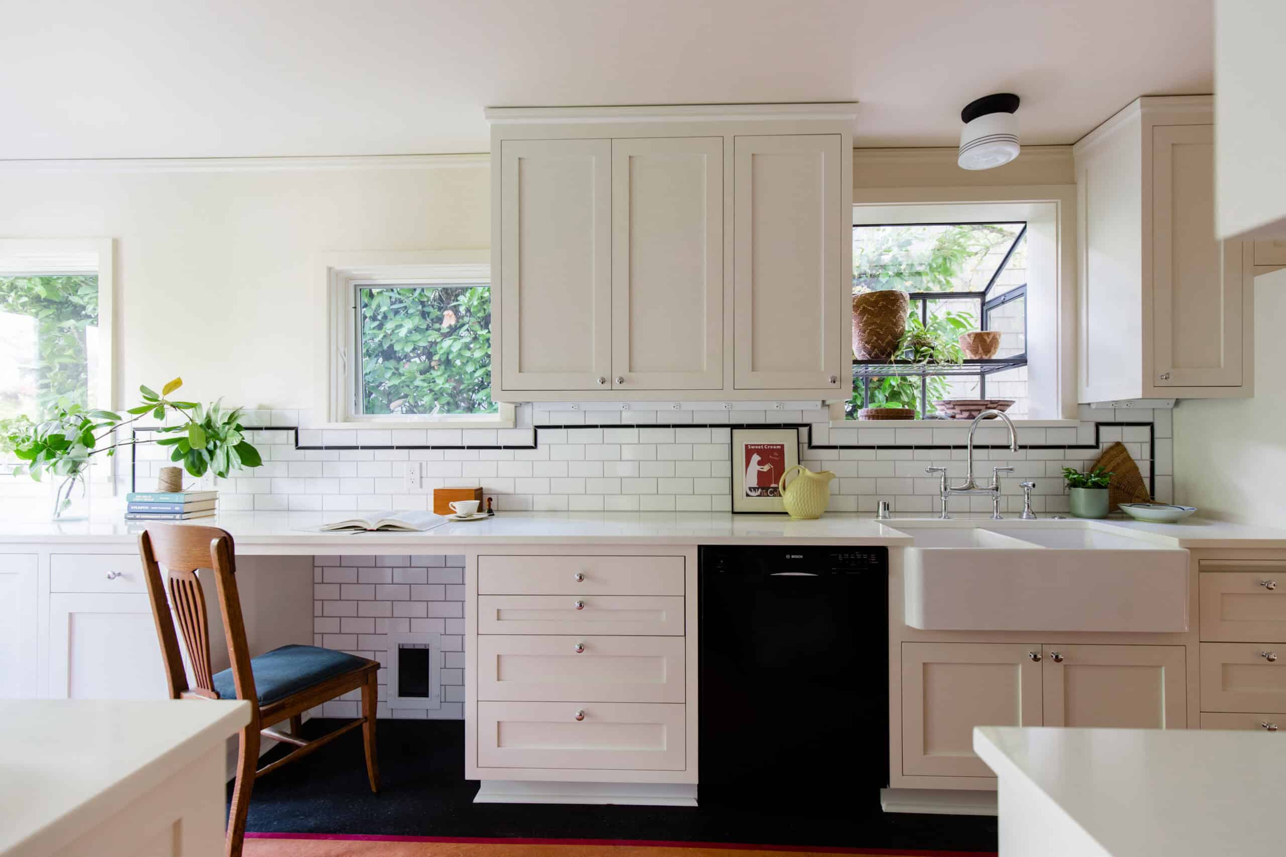 Bright vintage-inspired kitchen with white cabinets and farmhouse sink.