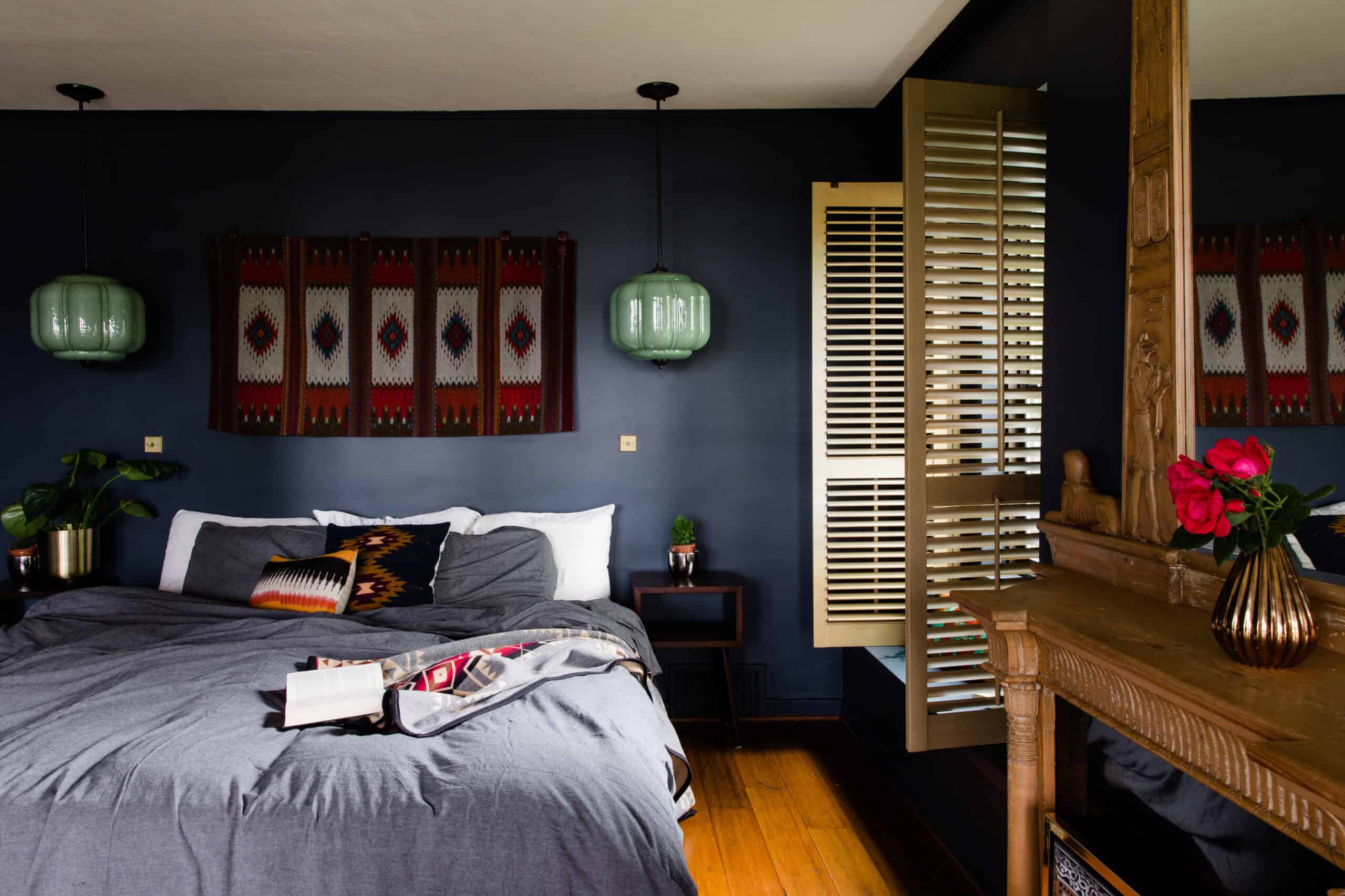 Modern bedroom with Spanish Colonial Revival decor and vibrant textiles.