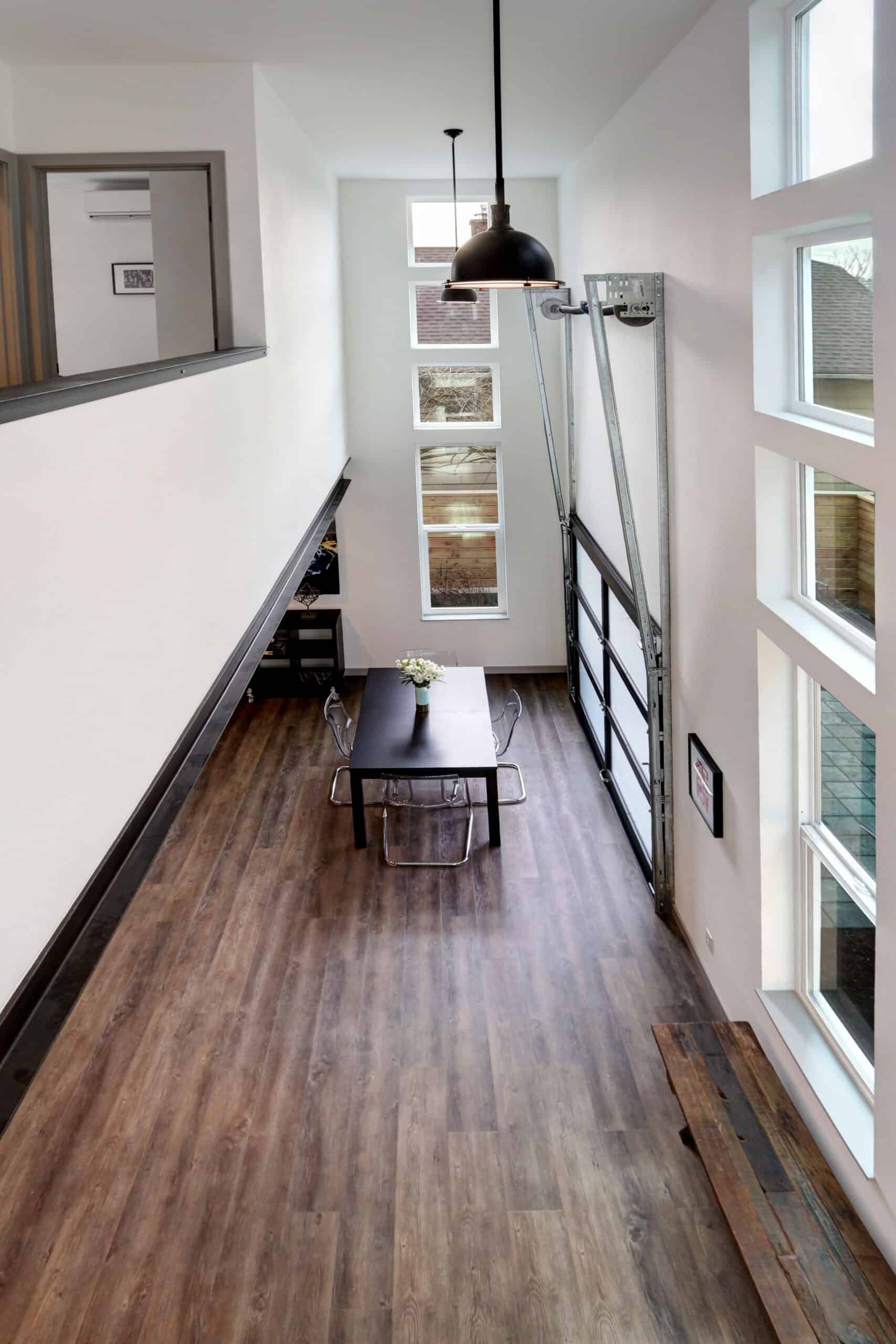 Modern interior with large windows and wooden flooring in a community space.