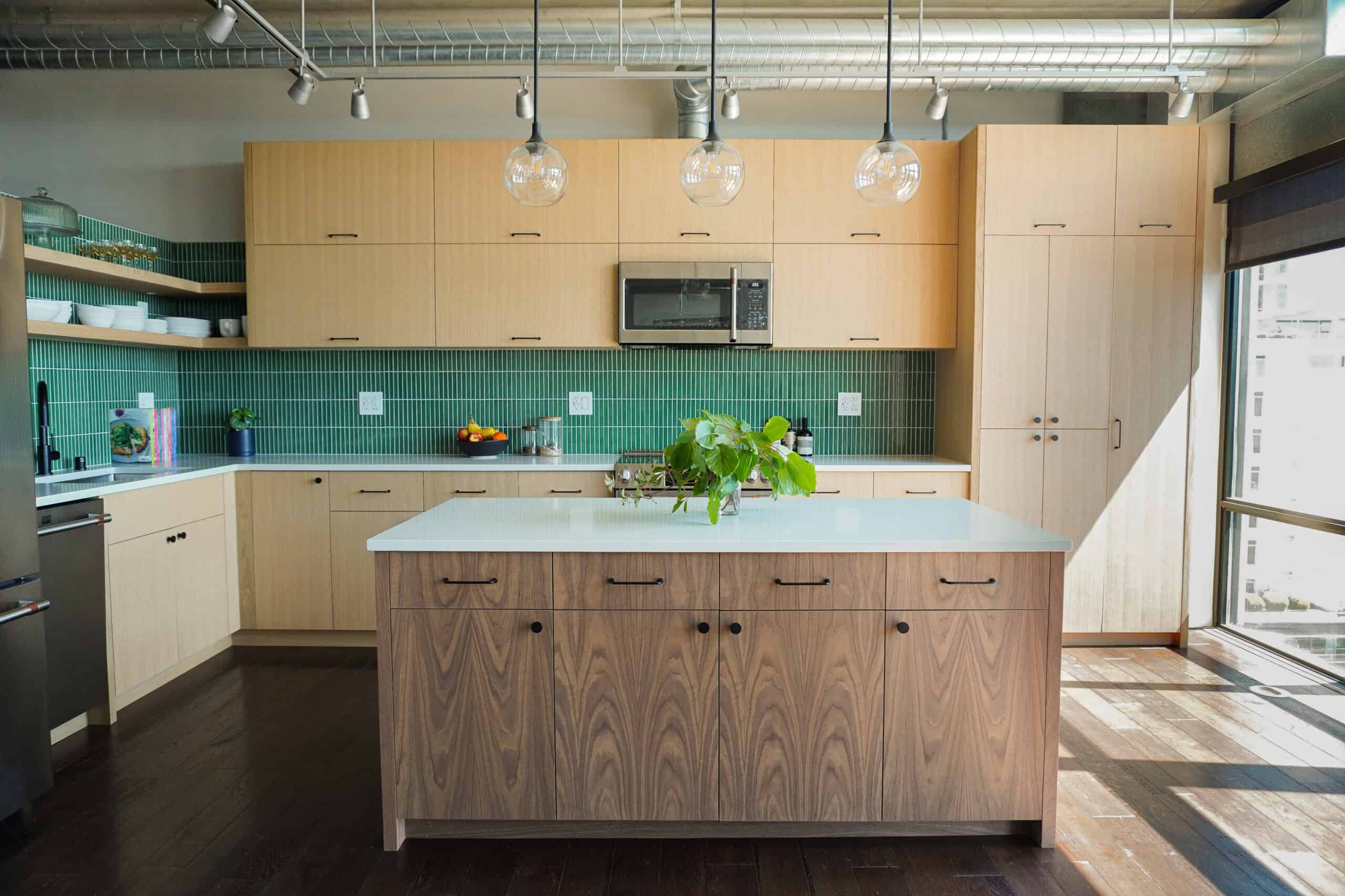 Modern kitchen with wooden cabinets and green tiled backsplash in Uptown Kitchen.