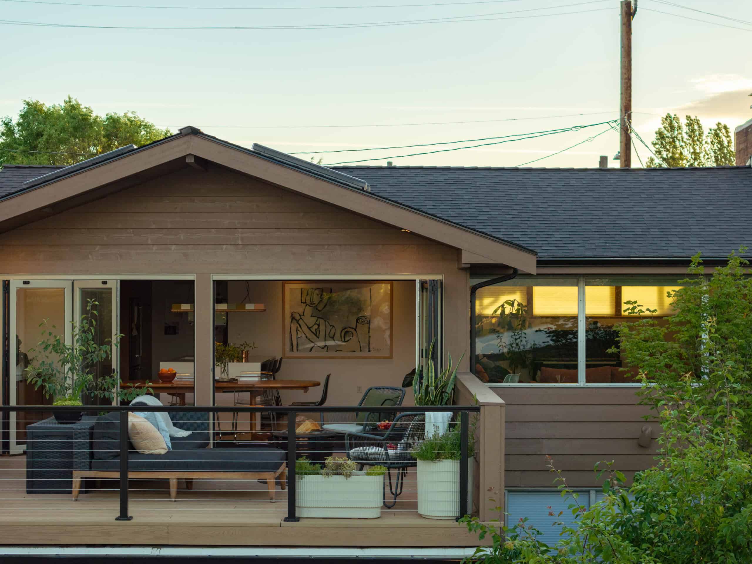 Contemporary house with large windows and outdoor patio area.