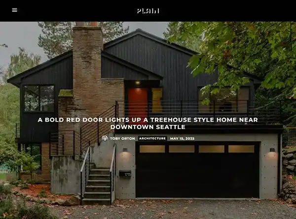 Modern treehouse-style home near downtown Seattle with bold red door and black exterior.