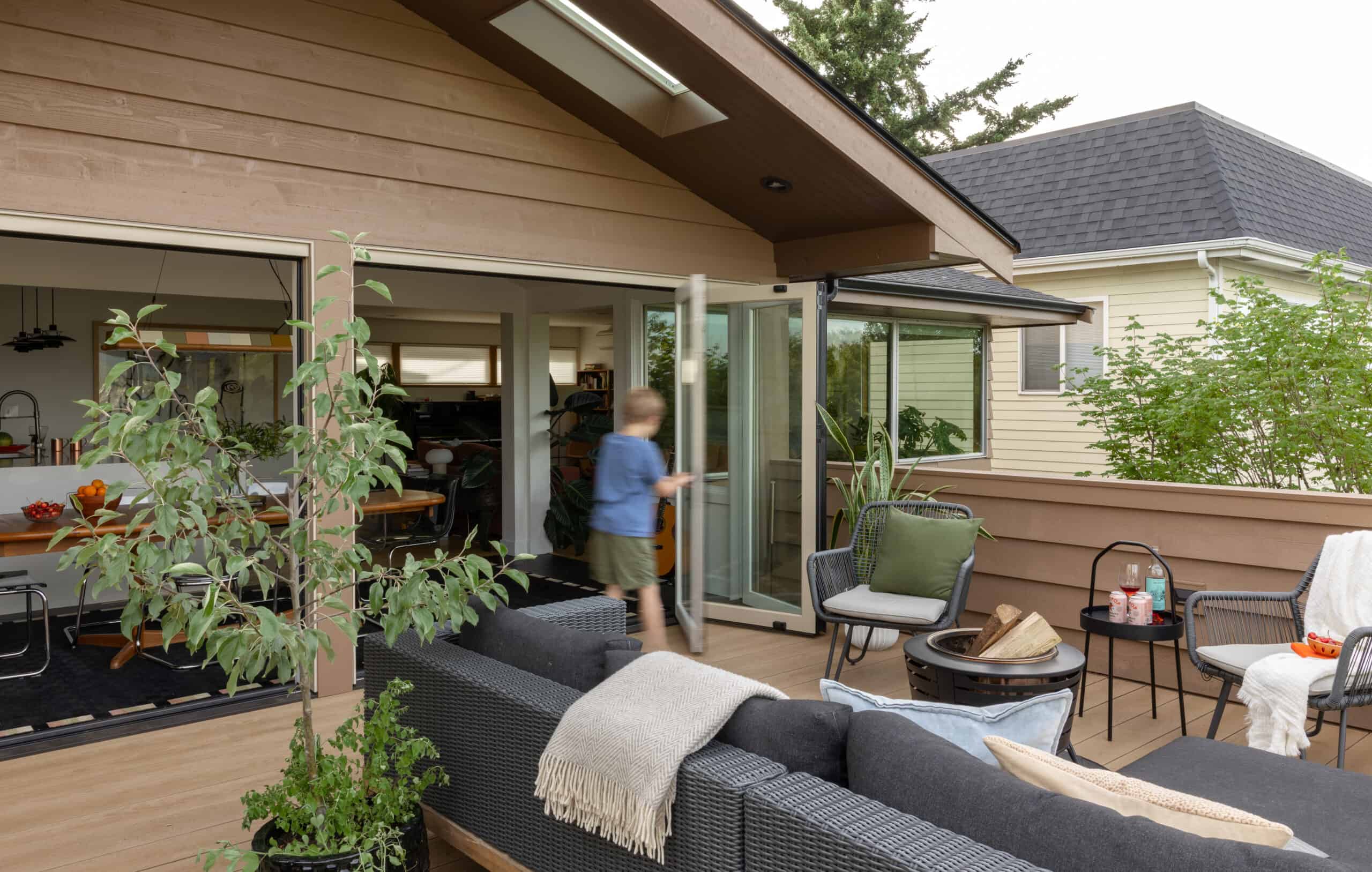 Modern rooftop deck with outdoor seating and greenery in Rainier Beach Garage + Roof Deck.