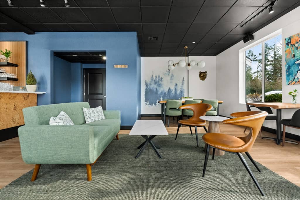 Modern interior of Office of Ordinary Architecture with colorful furniture and artwork.